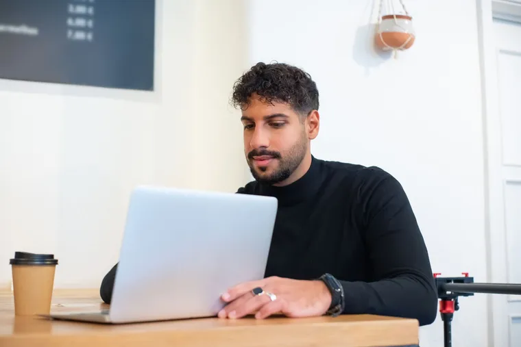 A man joining a telehealth consultation on his laptop